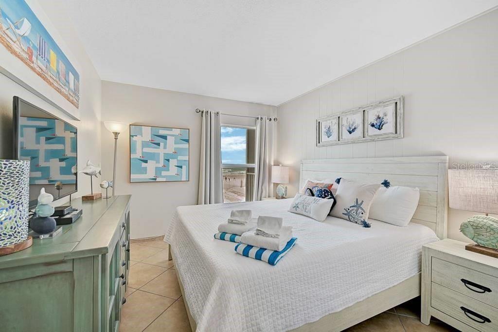 6154 Midnight Pass Road, Unit 206 Sarasota, FL 34242 - Photo 9 of 9 a bedroom with a bed and wooden floor