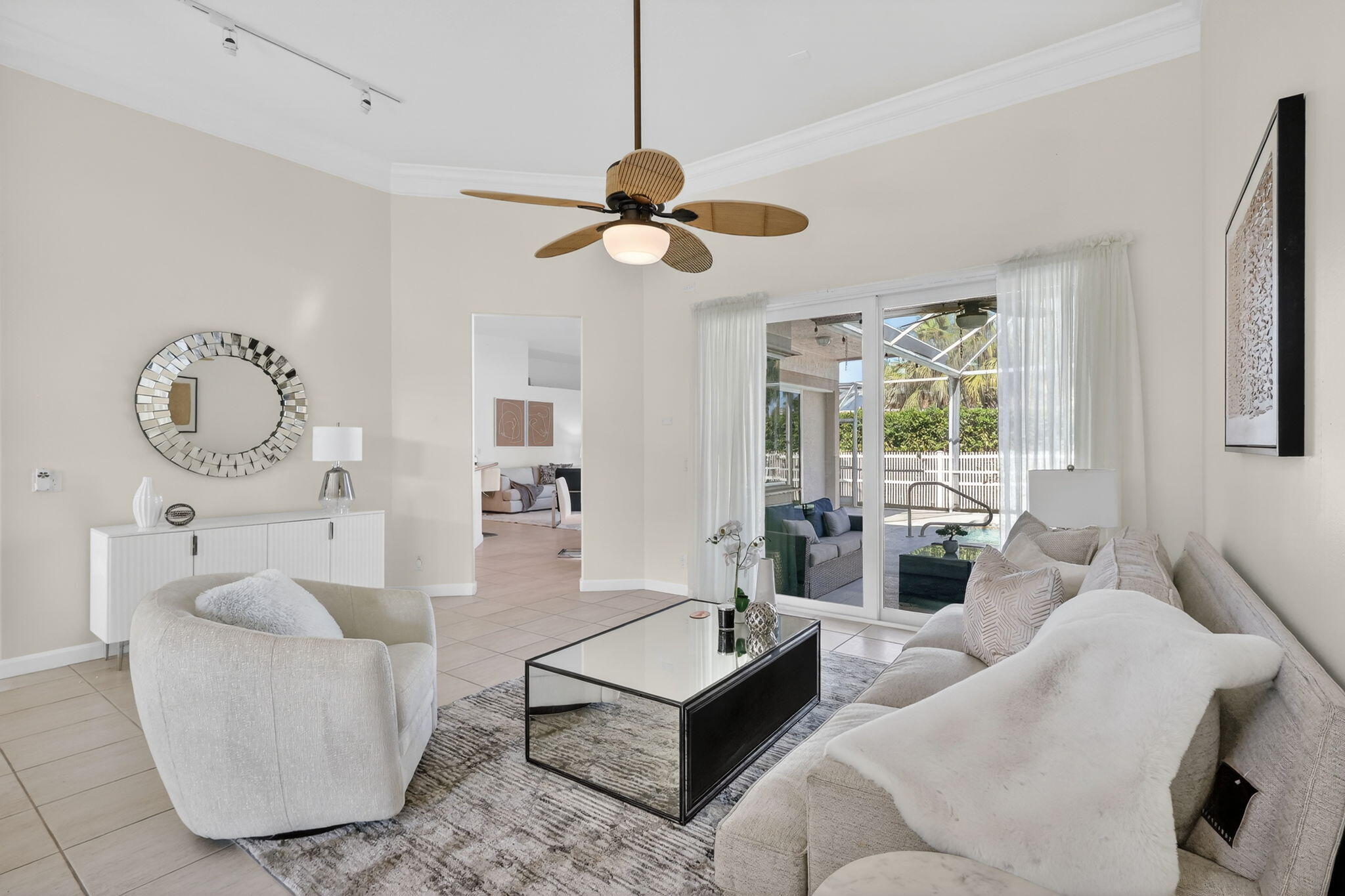 18981 Southeast Outrigger Lane Jupiter, FL 33458 - Photo 17 of 79 a living room with furniture a large window and a chandelier