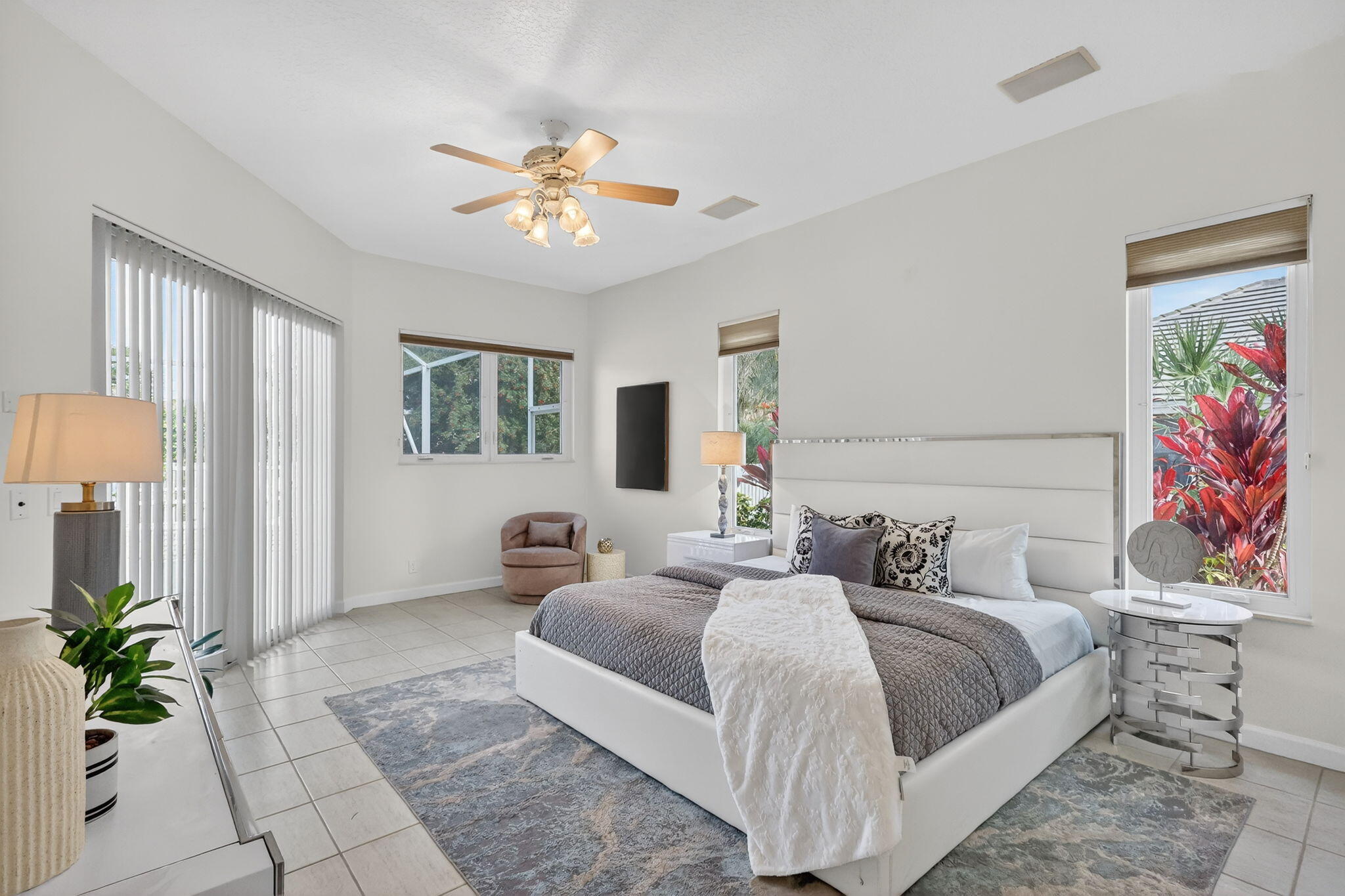 18981 Southeast Outrigger Lane Jupiter, FL 33458 - Photo 35 of 79 a bedroom with a bed and a chandelier