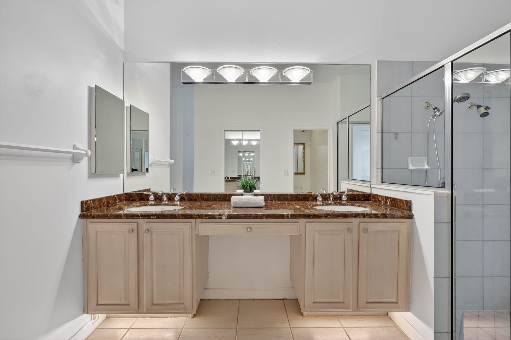 18981 Southeast Outrigger Lane Jupiter, FL 33458 - Photo 44 of 79 a bathroom with a granite countertop sink a mirror and a shower