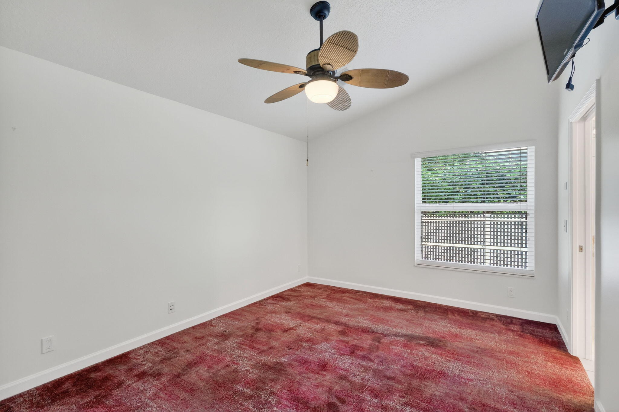 18981 Southeast Outrigger Lane Jupiter, FL 33458 - Photo 53 of 79 an empty room with a window and a ceiling fan