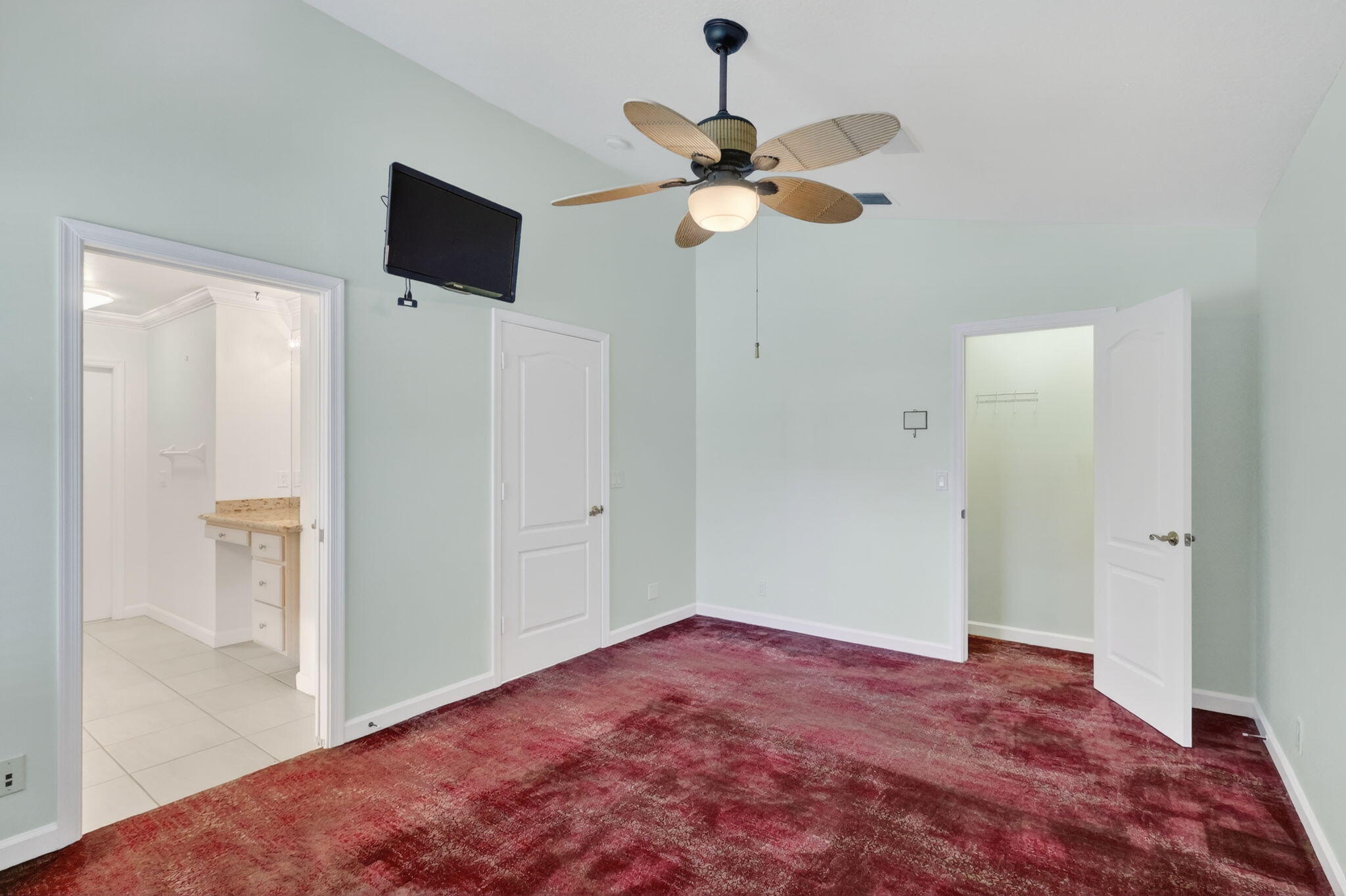 18981 Southeast Outrigger Lane Jupiter, FL 33458 - Photo 54 of 79 a view of a room with a flat screen tv and kitchen view