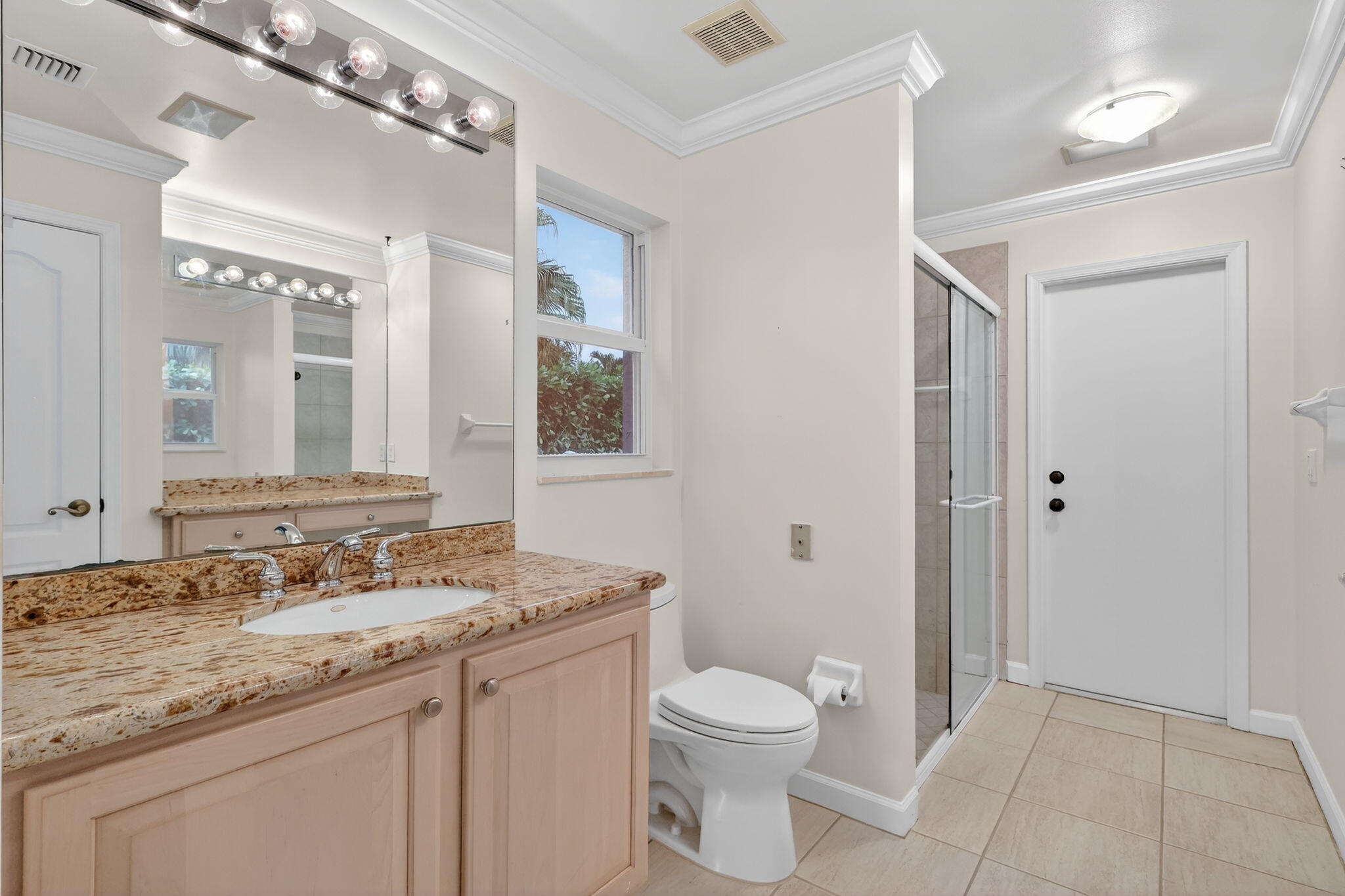 18981 Southeast Outrigger Lane Jupiter, FL 33458 - Photo 55 of 79 a bathroom with a granite countertop sink a toilet and a mirror