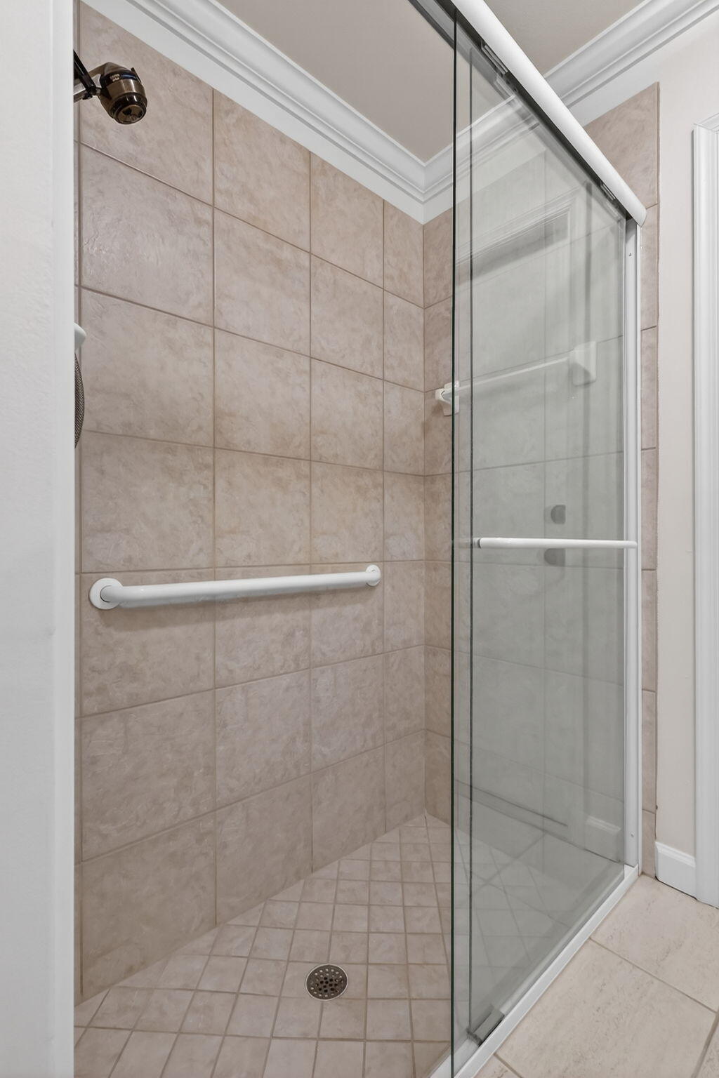 18981 Southeast Outrigger Lane Jupiter, FL 33458 - Photo 57 of 79 a bathroom with a glass shower door