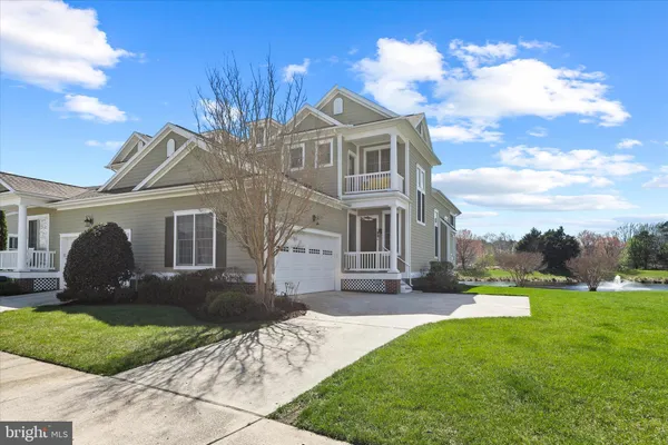 a front view of a house with garden and patio