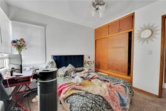 a bedroom with bed and a chandelier