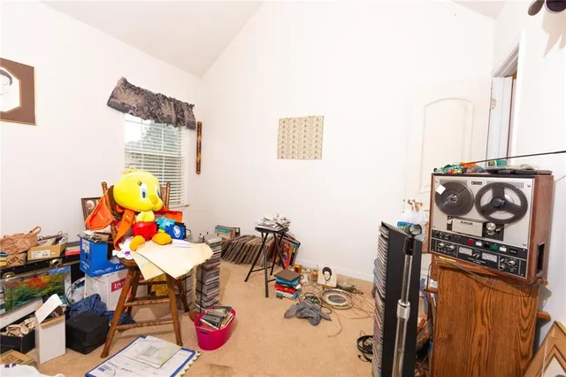 a bedroom with a bed and a lamp