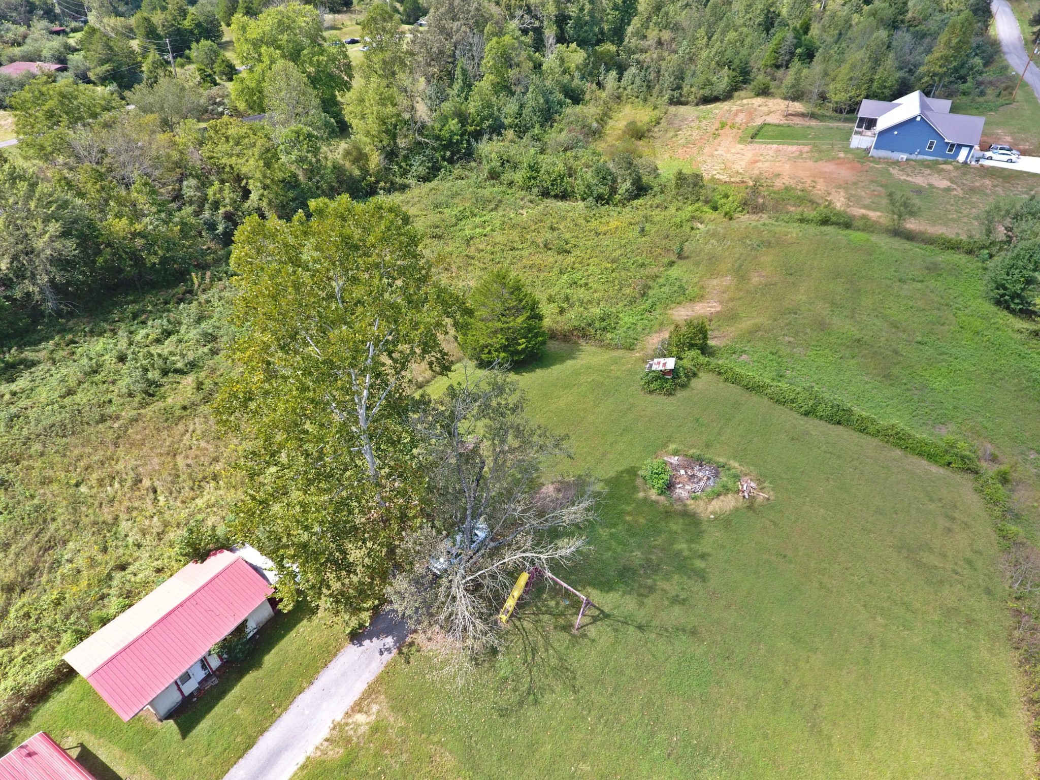 864 East Wolf Valley Road Heiskell, TN 37754 - Photo 15 of 17 a backyard of a house with a yard and outdoor seating