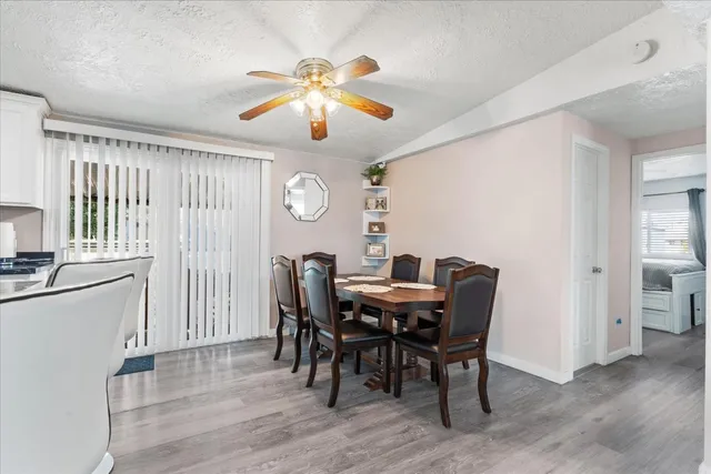 a view of a dining room with furniture and chandelier