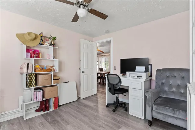 a view of a workspace with furniture and a bedroom