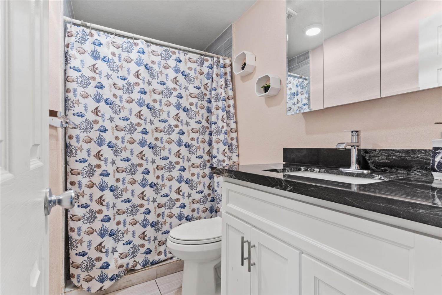 159 Village Circle Sacramento, CA 95838 - Photo 29 of 38 a view of a bathroom with a sink a toilet and a shower