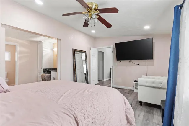 a bedroom with a bed and a flat screen tv