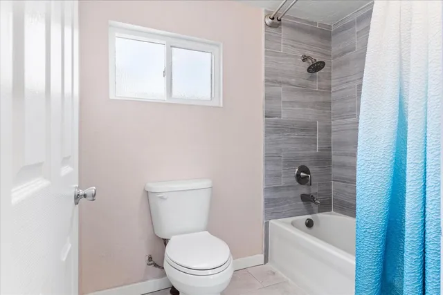 a bathroom with a toilet a sink and bathtub