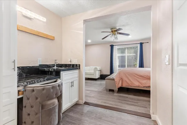 a kitchen with a stove cabinets and wooden floor