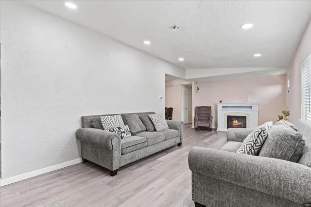 a living room with fireplace furniture and a fireplace
