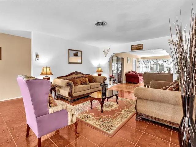 a living room with furniture a table and a fireplace