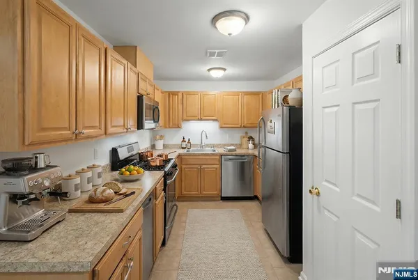a kitchen with a sink stove and refrigerator