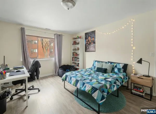 a bedroom with a bed a desk and chair