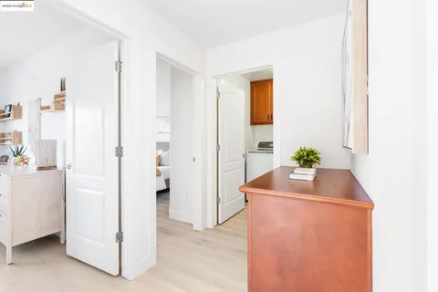 a room with kitchen island a sink a refrigerator and a window
