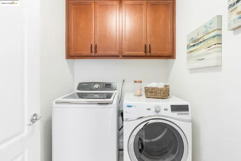 a view of a storage and utility room with washer and dryer