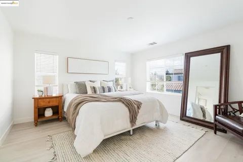 a bedroom with a bed and a mirror