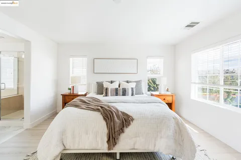 a bedroom with double bed and a large window