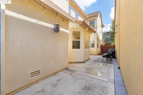 a view of a house with a big yard and large trees