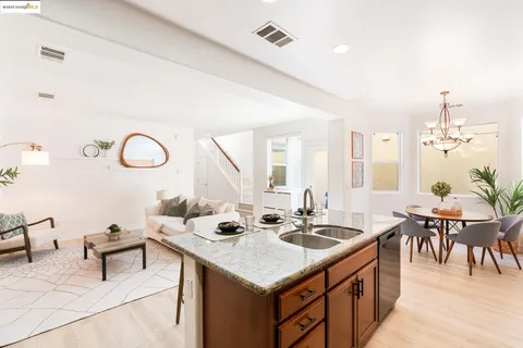 a room with furniture and view of kitchen