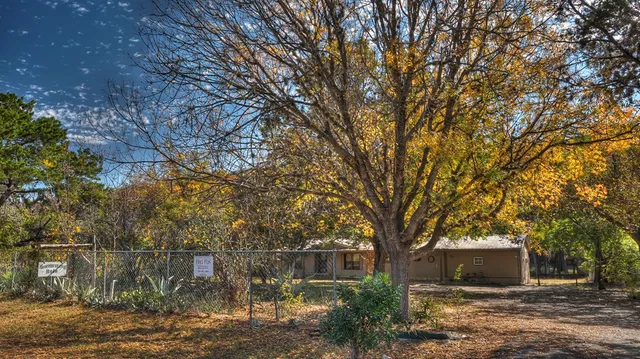 a view of a house with a backyard