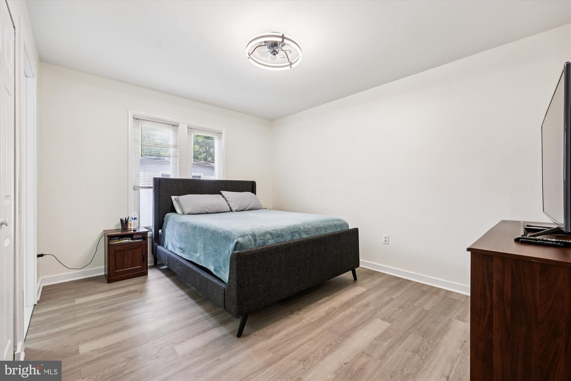 8313 Shady Spring Drive Gaithersburg, MD 20877 - Photo 12 of 30 a bedroom with a bed and wooden floor