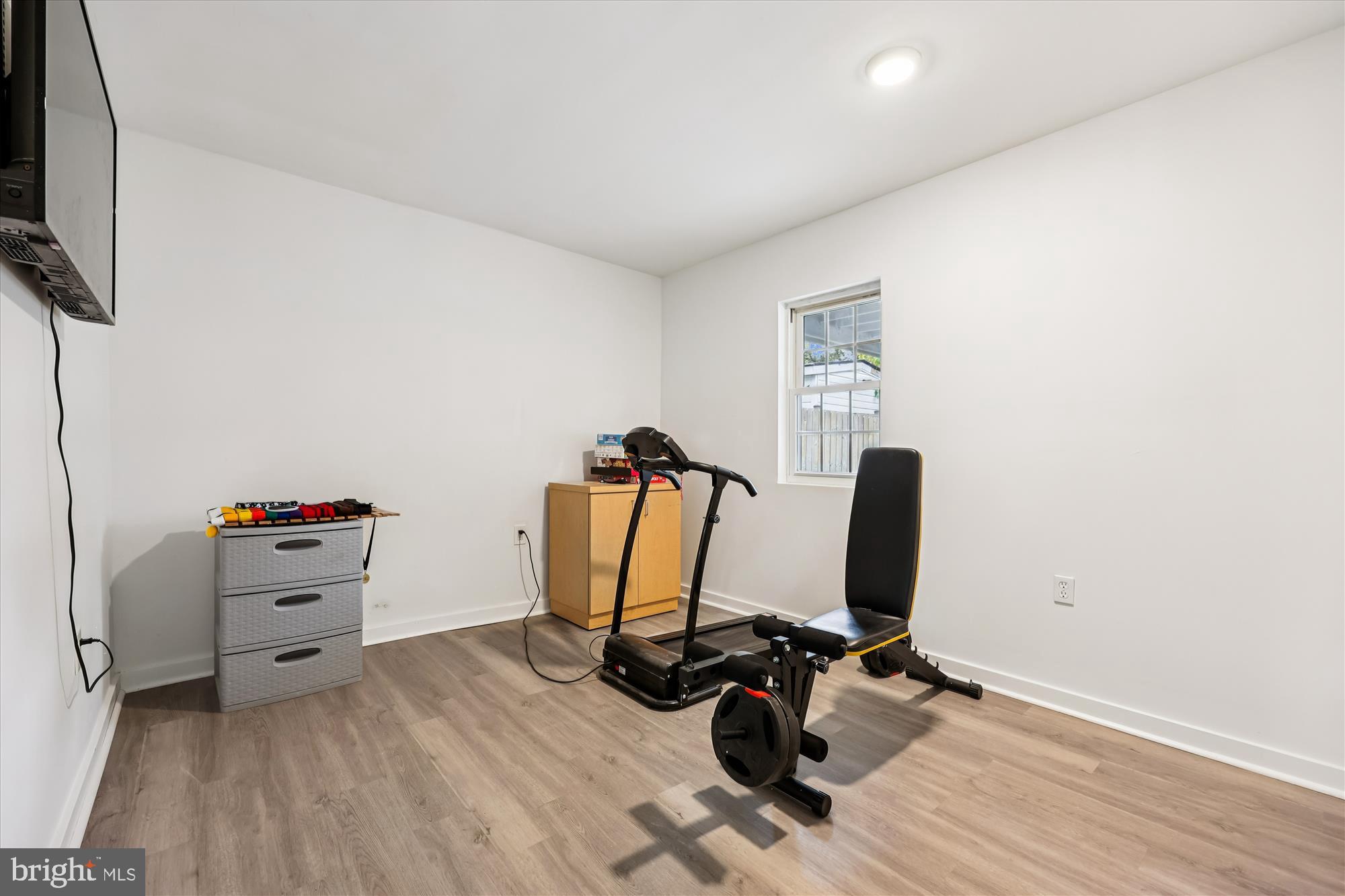 8313 Shady Spring Drive Gaithersburg, MD 20877 - Photo 19 of 30 a view of a workspace with furniture and a flat screen tv