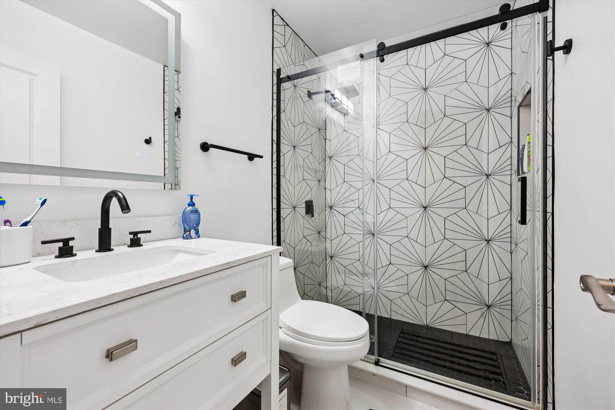8313 Shady Spring Drive Gaithersburg, MD 20877 - Photo 21 of 30 a bathroom with a sink toilet and shower