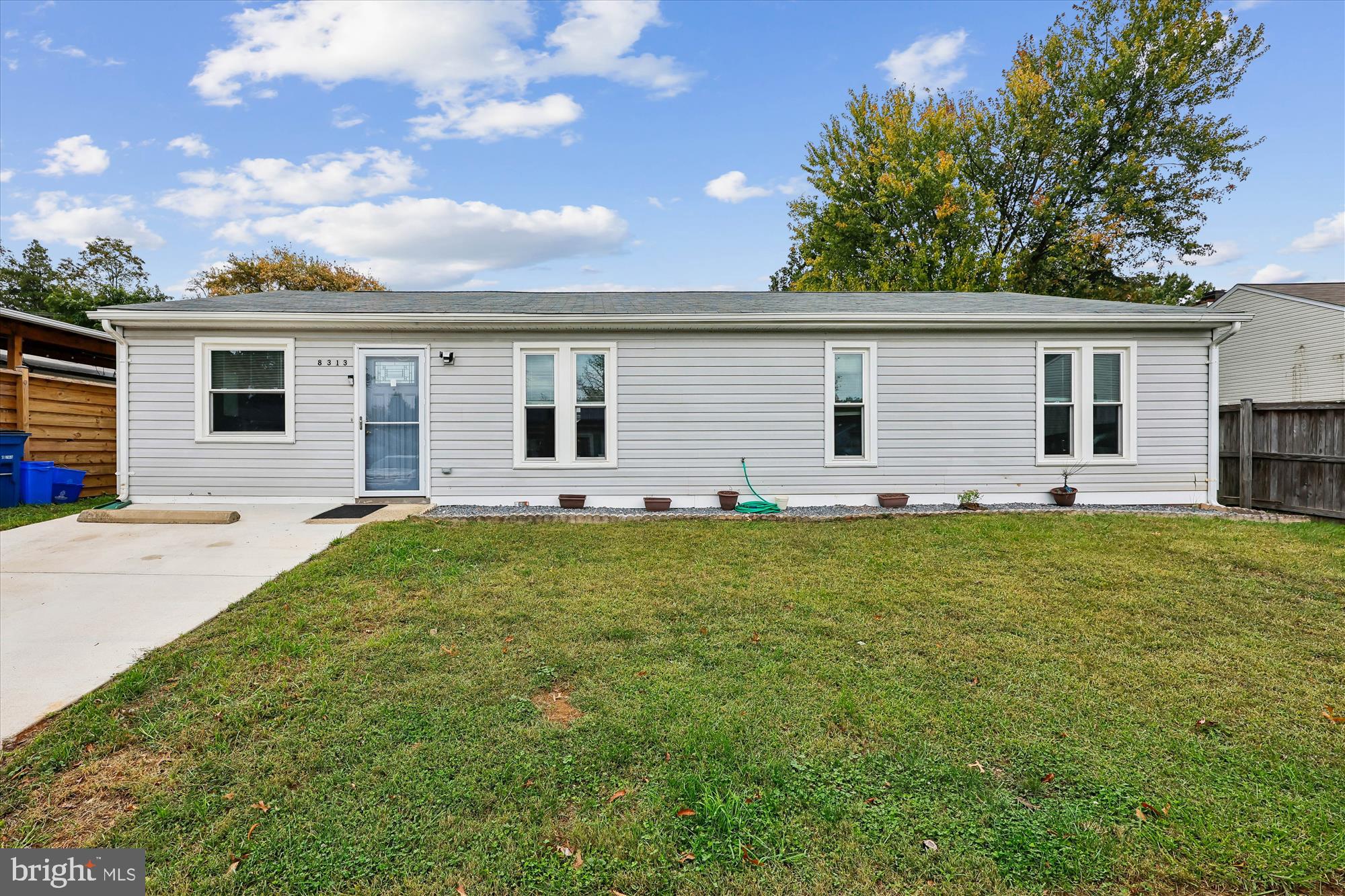 8313 Shady Spring Drive Gaithersburg, MD 20877 - Photo 22 of 30 a backyard of a house with large trees and table
