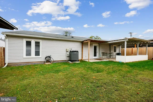 a view of a house with a backyard and porch