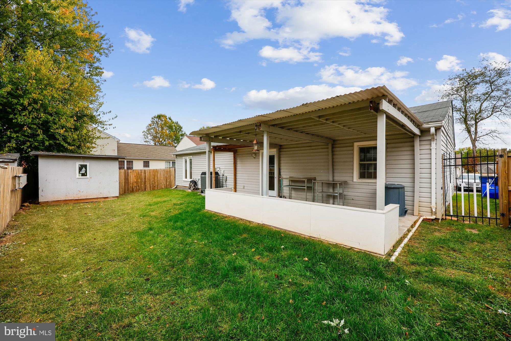 8313 Shady Spring Drive Gaithersburg, MD 20877 - Photo 26 of 30 a view of a house with a yard and a large tree