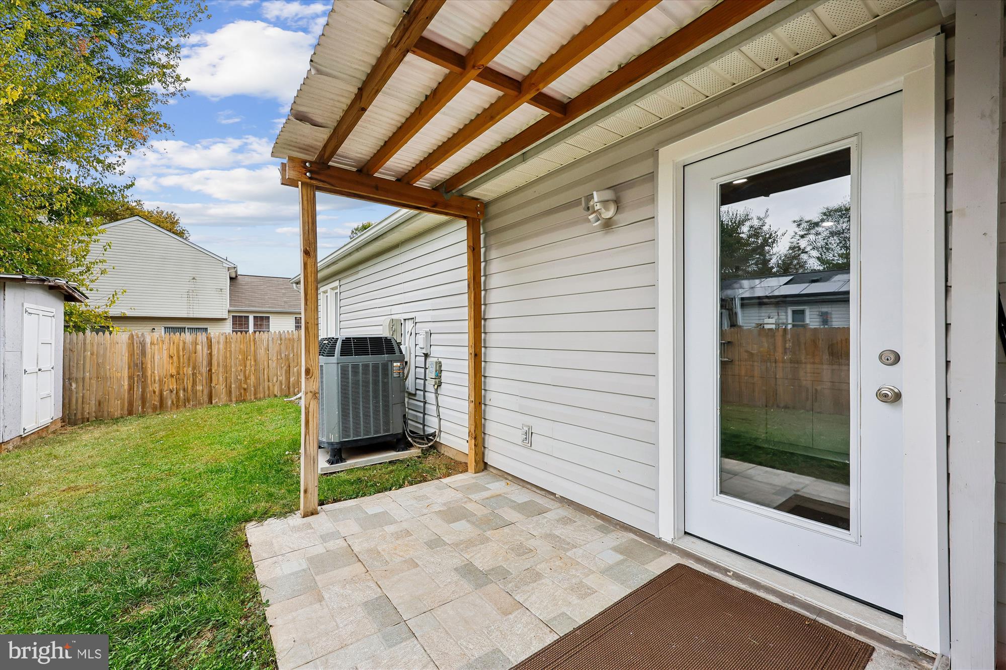 8313 Shady Spring Drive Gaithersburg, MD 20877 - Photo 28 of 30 a backyard of a house with garden and brick wall
