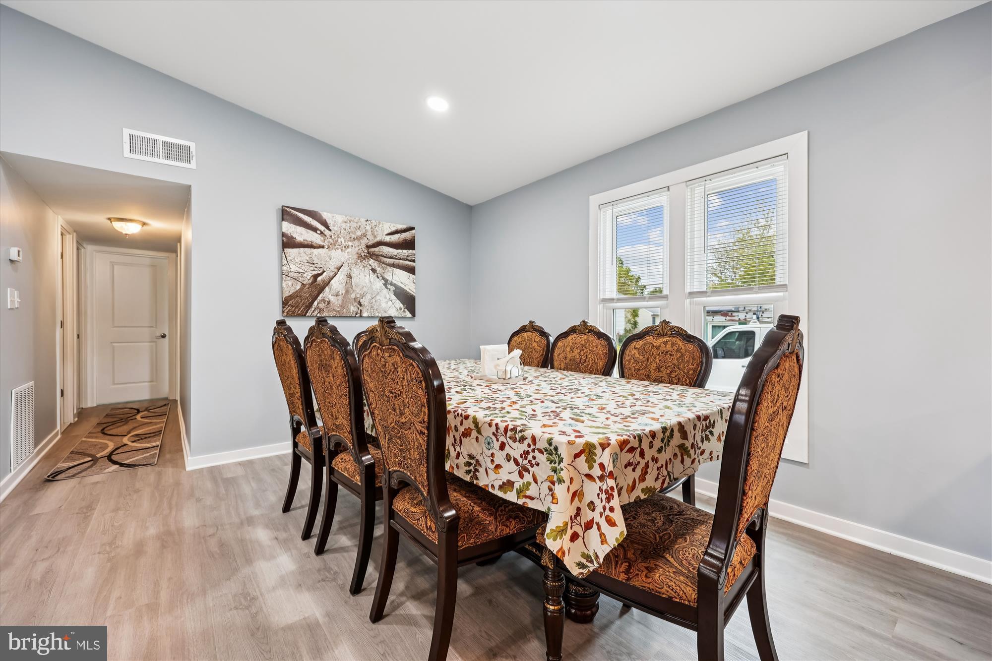 8313 Shady Spring Drive Gaithersburg, MD 20877 - Photo 3 of 30 a view of a dining room with furniture and wooden floor