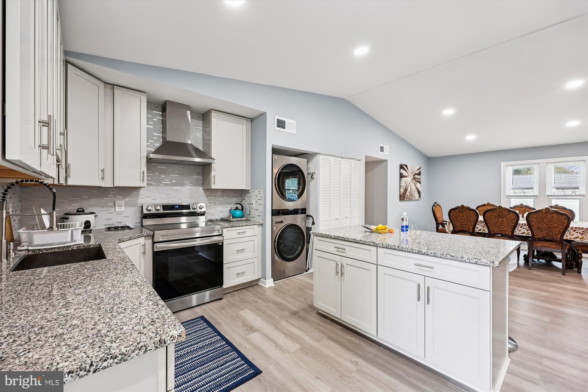 8313 Shady Spring Drive Gaithersburg, MD 20877 - Photo 10 of 30 a kitchen with stainless steel appliances granite countertop a stove and white cabinets
