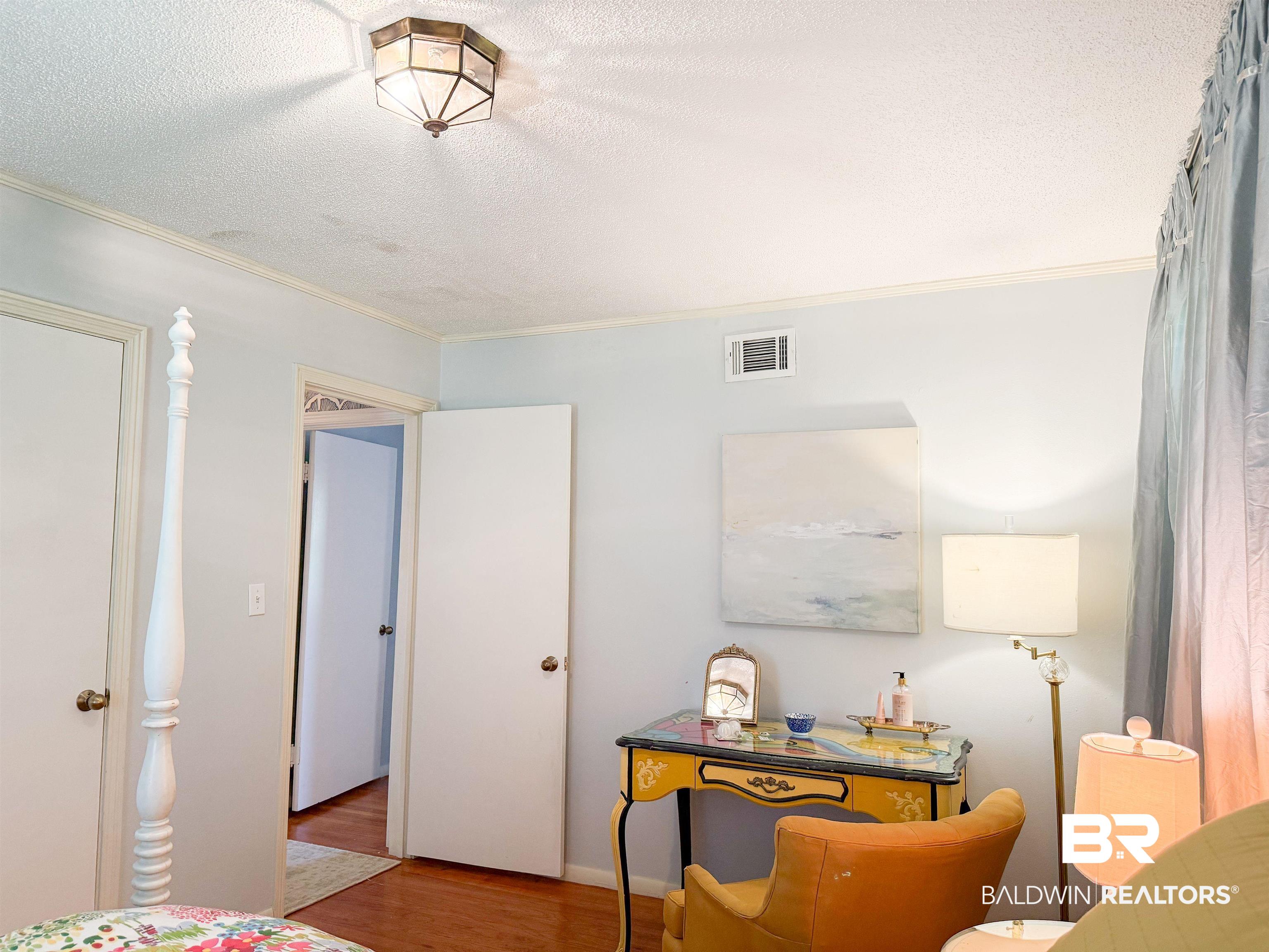 1508 Poplar Avenue Brewton, AL 36426 - Photo 12 of 22 Bedroom with wood finished floors, a textured ceiling, and crown molding