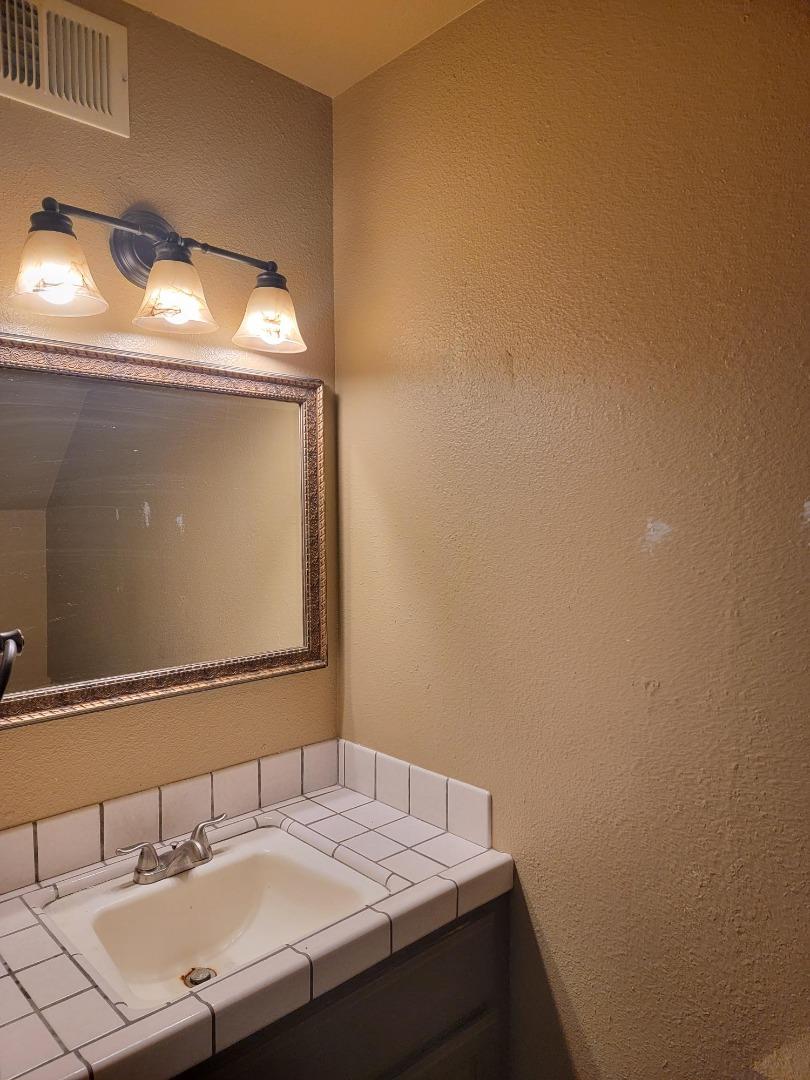 801 Nash Road, Unit A9 Hollister, CA 95023 - Photo 4 of 13 a bathroom with a sink and a mirror