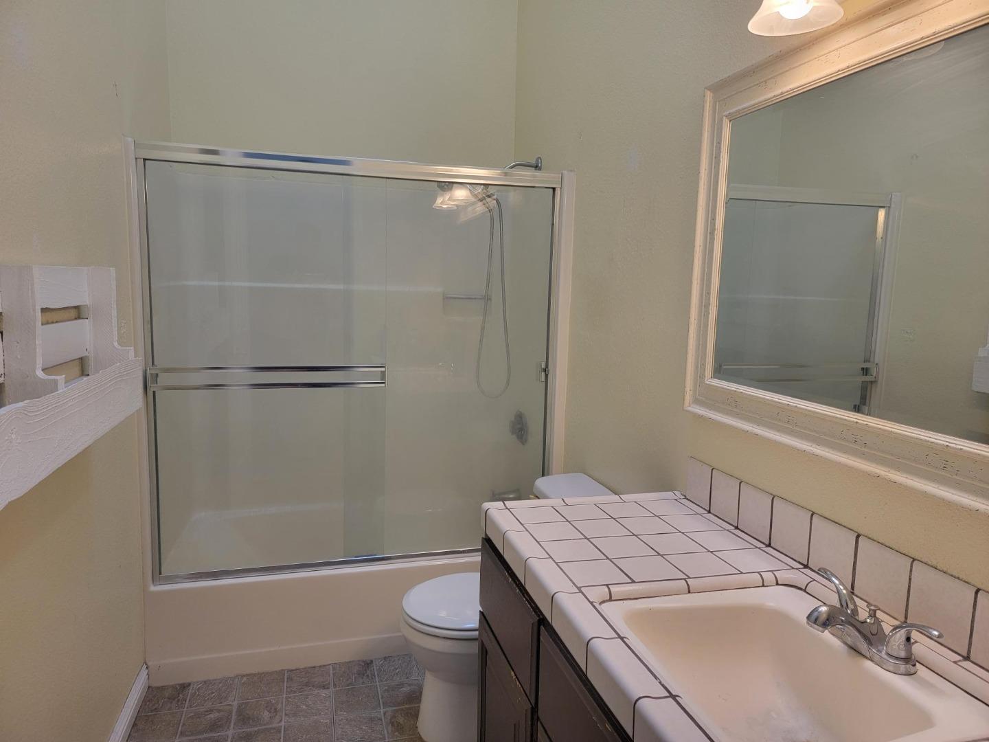 801 Nash Road, Unit A9 Hollister, CA 95023 - Photo 8 of 13 a bathroom with a sink toilet and shower