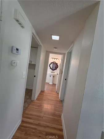 a view of a hallway with wooden floor