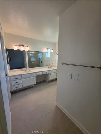 a bathroom with a shower and a glass door