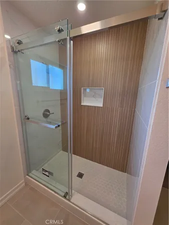 a bathroom with a granite countertop toilet and a sink