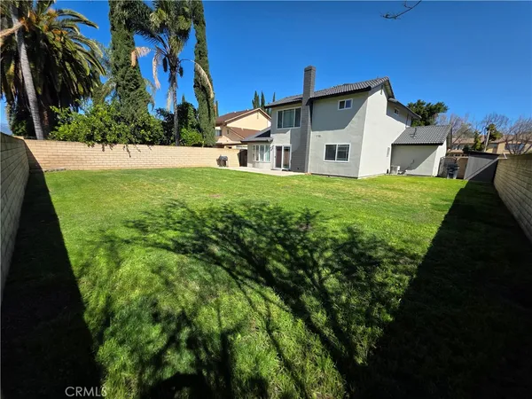 a front view of a house with a garden and yard