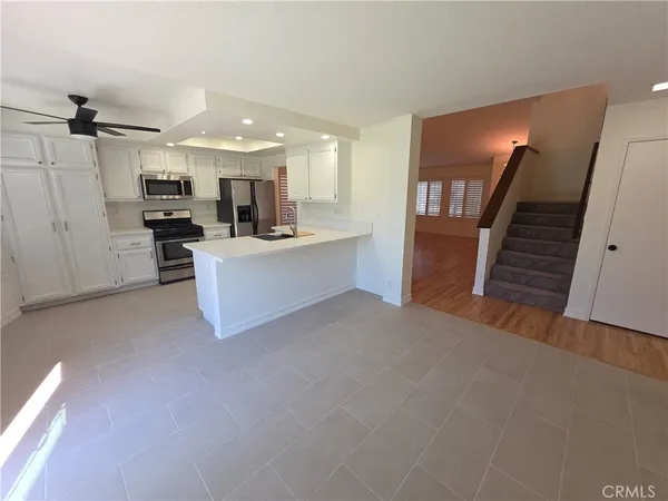 a view of kitchen and hall with wooden floor