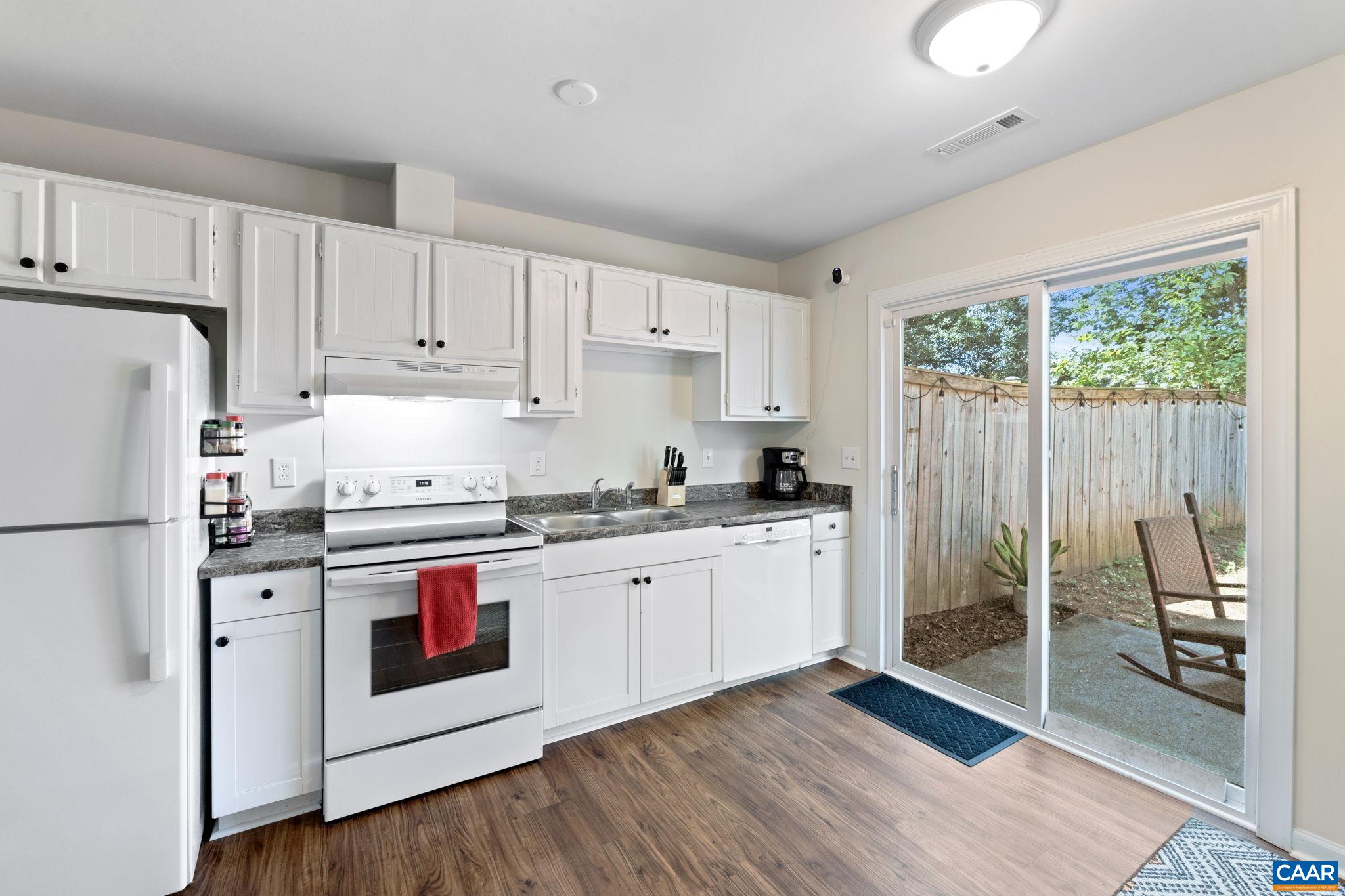 705 Prospect Avenue Charlottesville, VA 22903 - Photo 12 of 38 a kitchen with granite countertop white cabinets and white appliances