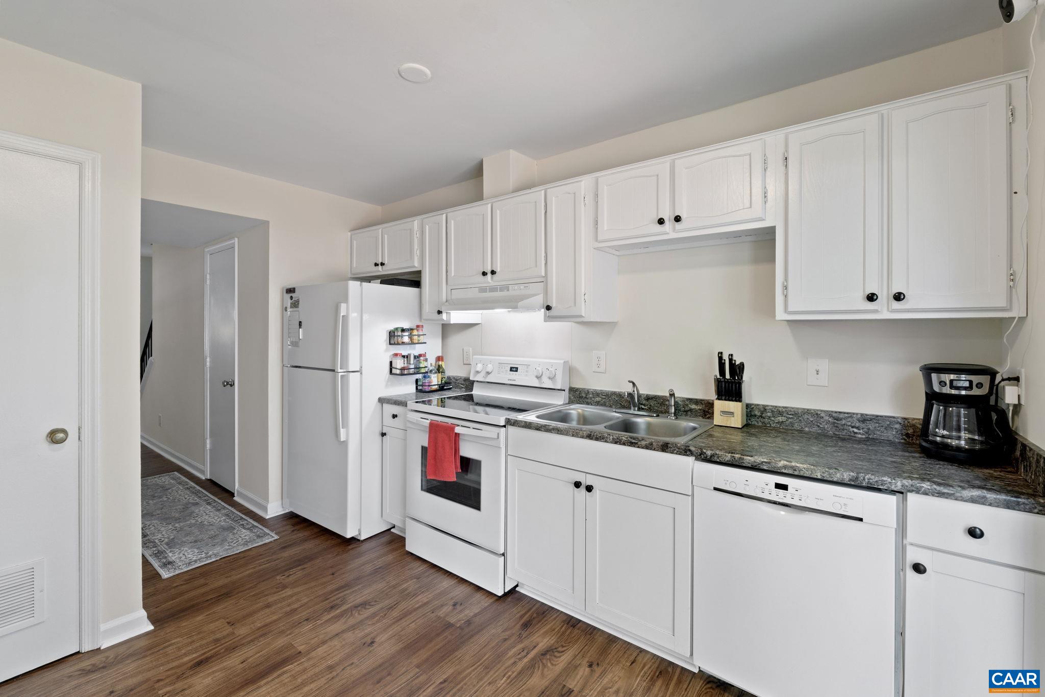 705 Prospect Avenue Charlottesville, VA 22903 - Photo 15 of 38 a kitchen with granite countertop white cabinets and white appliances