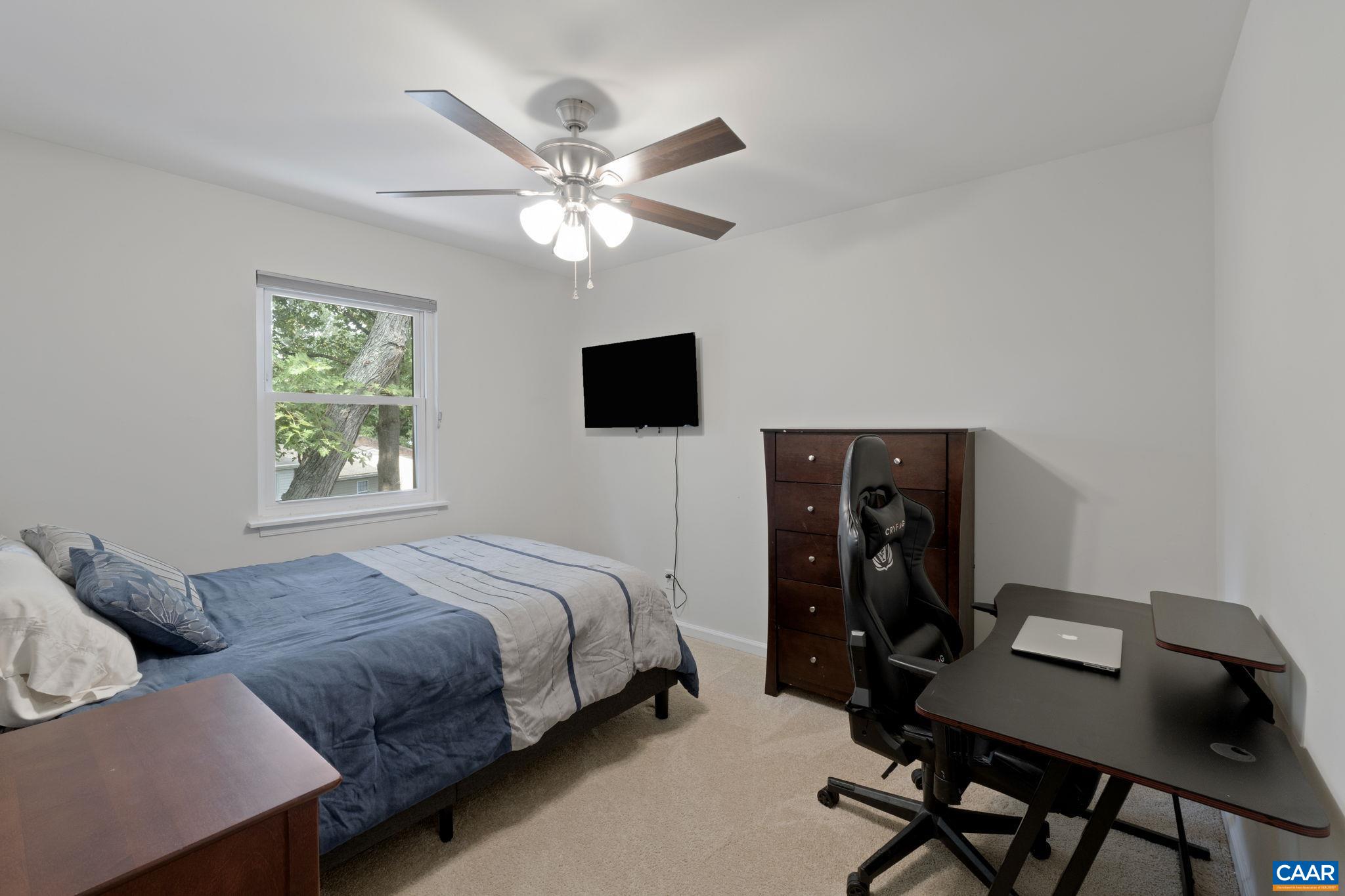 705 Prospect Avenue Charlottesville, VA 22903 - Photo 20 of 38 a bedroom with a bed and a flat screen tv