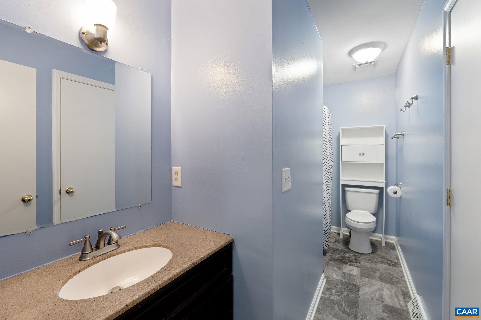 705 Prospect Avenue Charlottesville, VA 22903 - Photo 21 of 38 a bathroom with a granite countertop sink toilet and mirror